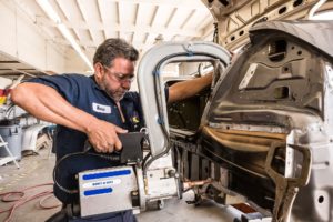 The Best Questions to Ask Your Collision Repair Shop After an Accident Auto Body Shop | Collision Repair Experts – Fix Auto USA professional auto body technician at work