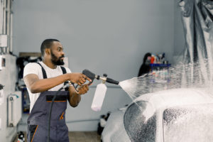 Are Car Washes Bad for Paint? Auto Body Shop | Collision Repair Experts – Fix Auto USA Worker performing a car wash with high pressure water jet and spray foam