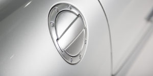 Close Up Of A Chrome Fuel Cap On A luxury White Car