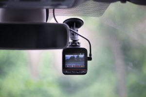 Pros and Cons of Having a Dash Cam Auto Body Shop | Collision Repair Experts – Fix Auto USA Dash camera in car installed on the window
