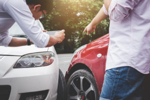 What Is a Fender Bender, and How to Handle One? Auto Body Shop | Collision Repair Experts – Fix Auto USA two men discussion after a minor fender bender