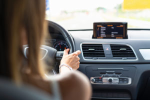 Woman Driving With Her Hands Firming Holding The Steering Wheel